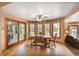 Dining room with hardwood floors, large windows, and access to the back patio at 12176 W Ohio Pl, Lakewood, CO 80228