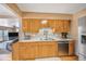 Well-equipped kitchen with stainless steel appliances, light wood cabinets, and ample counter space at 12176 W Ohio Pl, Lakewood, CO 80228