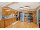 Functional kitchen with stainless steel appliances, wood cabinetry, and hardwood flooring at 12176 W Ohio Pl, Lakewood, CO 80228