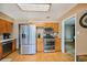 Spacious kitchen featuring stainless steel appliances, wooden cabinets, and hardwood floors at 12176 W Ohio Pl, Lakewood, CO 80228