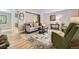 Inviting living room with hardwood floors, neutral decor, and a comfortable seating arrangement at 12176 W Ohio Pl, Lakewood, CO 80228