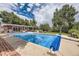 Backyard pool with brick accents and a covered patio for outdoor entertaining and relaxing by the water at 12176 W Ohio Pl, Lakewood, CO 80228