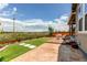 Landscaped backyard with covered patio, artificial turf, and neighborhood views at 14763 Pepper Pike Pl, Parker, CO 80134