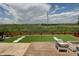 Spacious backyard with artificial turf, a charming patio area, and serene views of the neighborhood at 14763 Pepper Pike Pl, Parker, CO 80134