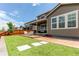 View of the backyard featuring the home's exterior, patio, artificial grass, and wooden fence at 14763 Pepper Pike Pl, Parker, CO 80134