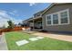 Beautiful backyard featuring a covered patio, artificial turf lawn, and a serene outdoor living space at 14763 Pepper Pike Pl, Parker, CO 80134