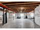 Unfinished basement with exposed ceiling, three windows, concrete floor, and plumbed for future bathroom at 14763 Pepper Pike Pl, Parker, CO 80134