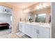 Bright bathroom with double vanity, white cabinets, and a view of the walk-in shower at 14763 Pepper Pike Pl, Parker, CO 80134