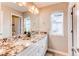 Elegant bathroom with double sink vanity, granite countertop, and ample lighting at 14763 Pepper Pike Pl, Parker, CO 80134