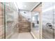 Ensuite bathroom with seamless glass shower doors, tile walls and flooring with a shower head at 14763 Pepper Pike Pl, Parker, CO 80134