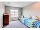 Bright bedroom with a large window offering neighborhood views, and neutral colored walls at 14763 Pepper Pike Pl, Parker, CO 80134