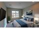 Comfortable bedroom featuring a large window and neutral decor at 14763 Pepper Pike Pl, Parker, CO 80134