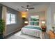 Cozy bedroom features a queen size bed with decorative pillows and a modern ceiling fan at 14763 Pepper Pike Pl, Parker, CO 80134