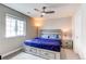 Comfortable bedroom featuring a ceiling fan, natural light, and neutral decor at 14763 Pepper Pike Pl, Parker, CO 80134
