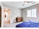 Cozy bedroom featuring a ceiling fan, natural light, and a sleek wooden dresser at 14763 Pepper Pike Pl, Parker, CO 80134