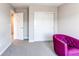 Cozy bedroom featuring a plush chair, ample natural light, and large closet at 14763 Pepper Pike Pl, Parker, CO 80134
