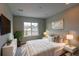 A bright bedroom with a large window and cozy, soft bedding at 14763 Pepper Pike Pl, Parker, CO 80134