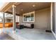 Covered patio with a wicker sofa and table and privacy from a wood fence at 14763 Pepper Pike Pl, Parker, CO 80134