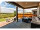 Covered patio with wicker furniture, fire pit, and view of the open space at 14763 Pepper Pike Pl, Parker, CO 80134