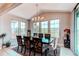 Elegant dining room with a large table, decorative chairs, and plenty of natural light from the surrounding windows at 14763 Pepper Pike Pl, Parker, CO 80134