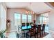 Bright dining room featuring a large wooden table, and natural light from large windows and a sliding door to the patio at 14763 Pepper Pike Pl, Parker, CO 80134