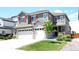 Charming two-story home featuring a three-car garage, red shutters, stone accents and a well-manicured front yard at 14763 Pepper Pike Pl, Parker, CO 80134