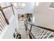 Spacious foyer showing the staircase, hardwood floors, and a view of the living room below, open and airy at 14763 Pepper Pike Pl, Parker, CO 80134