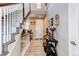 Elegant foyer with hardwood floors, a staircase with white railings, and stylish decor for a welcoming entrance at 14763 Pepper Pike Pl, Parker, CO 80134
