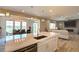 Modern kitchen featuring white cabinets, stainless steel appliances, and a large kitchen island at 14763 Pepper Pike Pl, Parker, CO 80134