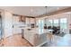 Modern kitchen featuring white cabinets, stainless steel appliances, and a large island with seating, bright at 14763 Pepper Pike Pl, Parker, CO 80134