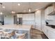 Bright kitchen features a large island, stainless steel appliances, and modern lighting fixtures at 14763 Pepper Pike Pl, Parker, CO 80134