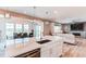 Open concept kitchen with a large island seamlessly connects to the dining and living areas at 14763 Pepper Pike Pl, Parker, CO 80134