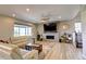 Bright living room with a modern fireplace, large windows, and sleek flooring at 14763 Pepper Pike Pl, Parker, CO 80134