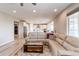 A bright living room with an open floor plan and seamless connection to the modern kitchen at 14763 Pepper Pike Pl, Parker, CO 80134