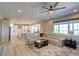 Spacious living room showcasing a large sectional sofa, ceiling fan, and ample natural light at 14763 Pepper Pike Pl, Parker, CO 80134