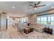 Bright and airy living room and kitchen with hardwood floors, a large comfortable sofa and stylish decor at 14763 Pepper Pike Pl, Parker, CO 80134