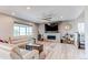 Open-concept living room showcasing a fireplace, a large TV, and stylish furnishings at 14763 Pepper Pike Pl, Parker, CO 80134