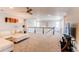 Spacious loft area with a comfortable sofa, ample lighting, and staircase at 14763 Pepper Pike Pl, Parker, CO 80134