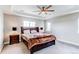 Cozy main bedroom features tray ceiling, large windows, and decorative bedside lamps at 14763 Pepper Pike Pl, Parker, CO 80134