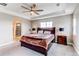 Bright bedroom with decorative tray ceiling, luxurious wood furniture and connected bath at 14763 Pepper Pike Pl, Parker, CO 80134