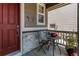 Inviting porch with a table and chairs, perfect for relaxing and enjoying the outdoors with light stone facade at 14763 Pepper Pike Pl, Parker, CO 80134
