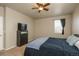 Well-lit bedroom with neutral walls, ceiling fan and window with dark curtains for privacy at 6434 N Ensenada Ct, Aurora, CO 80019