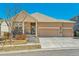Charming single-Gathering home with a three-car garage and stone veneer accents on a sunny day at 6434 N Ensenada Ct, Aurora, CO 80019