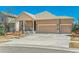 Inviting home featuring a three-car garage, stone accents, and a well-maintained front yard at 6434 N Ensenada Ct, Aurora, CO 80019