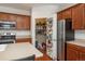 Spacious kitchen featuring an island, stainless steel appliances, and a convenient pantry at 6434 N Ensenada Ct, Aurora, CO 80019