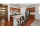 Spacious kitchen featuring a breakfast bar, stainless steel appliances, and wood flooring at 6434 N Ensenada Ct, Aurora, CO 80019