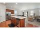 Open-concept kitchen with stainless steel appliances, center island, and seamless flow to the living area at 6434 N Ensenada Ct, Aurora, CO 80019