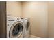 Laundry room equipped with modern washer and dryer units at 6434 N Ensenada Ct, Aurora, CO 80019
