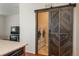 Laundry room with barn door and washer and dryer units at 6434 N Ensenada Ct, Aurora, CO 80019