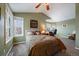 Serene bedroom with green walls, plush carpeting, a large bed, and a cozy reading nook at 14335 W Wesley Cir, Lakewood, CO 80228